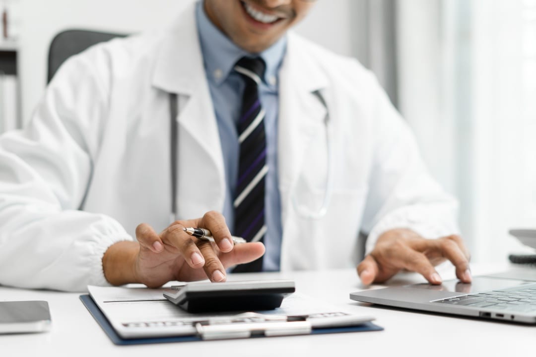 Doctor working in hospital use calculator, Healthcare and medical concept.