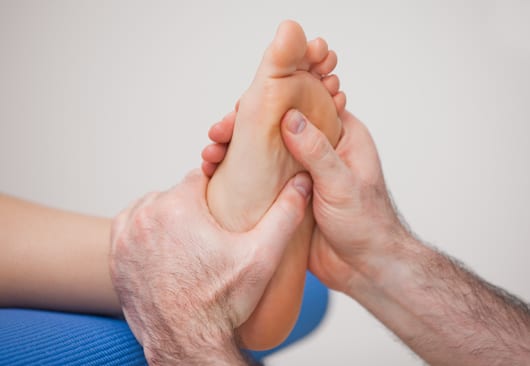 Practitioner locating the treatment area by palpation